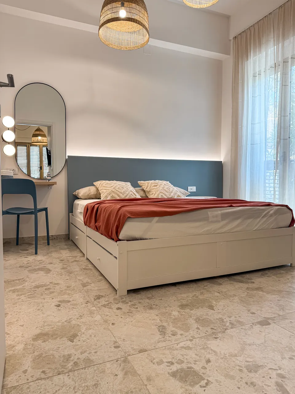 Schlafzimmer der Casa Tramonto mit Doppelbett, Frisiertisch und großem Fenster